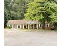 Traditional brick home featuring a covered front porch with classic white columns at 3006 East Point Street, East Point, GA 30344