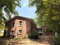 Rear view of a brick home, showcasing its architectural style and natural surroundings at 3006 East Point Street, East Point, GA 30344