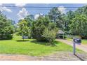 Inviting home with a well-maintained lawn, mature trees, and a traditional mailbox for added curb appeal at 502 Snowfall Ter, Palmetto, GA 30268