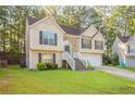 Charming two-story home with a manicured lawn, brick accents, and attached two-car garage at 5033 Kens Ct, Stockbridge, GA 30281