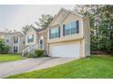 Charming two-story home with a manicured lawn, brick accents, and attached two-car garage at 5033 Kens Ct, Stockbridge, GA 30281