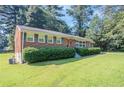 Well-maintained brick house with green shutters and a lush lawn at 573 Allgood Rd, Stone Mountain, GA 30083