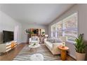 Bright living room featuring a striped rug, white furniture and large windows at 573 Allgood Rd, Stone Mountain, GA 30083