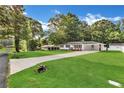 View of the well-maintained home with a spacious front yard and a long driveway on a sunny day at 288 Valerie Cir, Hiram, GA 30141