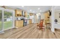 Bright kitchen with stainless steel appliances, wood cabinets, and wood-look vinyl flooring at 288 Valerie Cir, Hiram, GA 30141