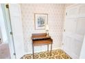 Charming entryway featuring a vintage desk, floral wallpaper, and classic patterned flooring at 4581 Newcastle Cir, Lithonia, GA 30038