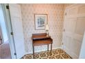 Welcoming hallway featuring a classic writing desk, complemented by patterned wallpaper and flooring at 4581 Newcastle Cir, Lithonia, GA 30038