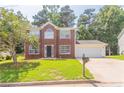 Traditional brick two-story home with a well-kept lawn and a convenient two-car garage at 5867 Heritage Walk, Lithonia, GA 30058