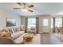 Bright living room featuring neutral decor, hardwood floors, and a cozy seating area at 5867 Heritage Walk, Lithonia, GA 30058