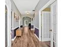 Inviting hallway with hardwood floors, neutral paint, and decorative wainscoting at 1002 Hallman Sw Ter, Marietta, GA 30064