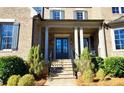 Inviting front entrance with stone steps, brick facade, and classic blue double doors at 1600 Nottingham Ne Way, Atlanta, GA 30309
