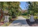 Community path featuring manicured landscaping and hardscape retaining walls at 3485 Parkbrooke Ln, Duluth, GA 30096