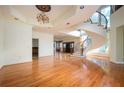 Elegant living room with hardwood floors, a grand spiral staircase, and modern chandelier at 1006 Arbor Ne Trce, Atlanta, GA 30319