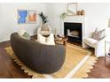 Bright living room featuring a fireplace, modern decor, and hardwood flooring throughout at 1334 Gates Se Dr, Atlanta, GA 30316