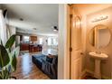 View of a living room featuring luxury vinyl flooring, open floorplan and half-bathroom at 1574 Leonard St, Hampton, GA 30228