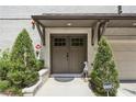 Charming double front doors flanked by lush greenery and a decorative statue at 1821 Huntington Hills Nw Ln, Atlanta, GA 30309