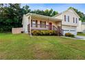 This well-maintained home features a front porch, two-car garage, green lawn, and privacy fencing in a residential area at 421 River Trace Dr, Villa Rica, GA 30180