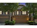 Attractive exterior of the townhome featuring a two-car garage and stone accents at 4349 Kousa Rd # 4, Austell, GA 30106