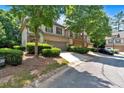 Street view of the townhome showcasing a two-car garage, landscaping, and a well-maintained facade at 4349 Kousa Rd # 4, Austell, GA 30106