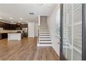 Inviting entryway featuring hardwood floors, staircase, and views of the kitchen at 6761 Cedar Glen Rd, Peachtree Corners, GA 30360