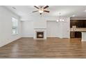 Open floor plan features a fireplace and chandelier with hardwood flooring throughout at 6761 Cedar Glen Rd, Peachtree Corners, GA 30360