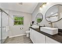 Sleek bathroom with dual vessel sinks, modern fixtures, a glass shower, and natural light at 3408 Phillips Cir, Decatur, GA 30032