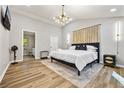 Tranquil main bedroom featuring a vaulted ceiling, a modern chandelier, and minimalist decor at 3408 Phillips Cir, Decatur, GA 30032