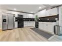 Bright, updated kitchen with stainless steel appliances, white cabinets, and sleek black countertops at 3408 Phillips Cir, Decatur, GA 30032