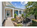 Inviting front porch with brick accents and landscaped garden at 3804 Tattenhall Drive Dr, Cumming, GA 30040