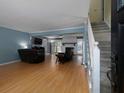 Spacious living room featuring hardwood floors, a fireplace, and a staircase leading to the second floor at 21 Queen Anne Se Dr, Mableton, GA 30126