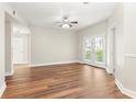 Bright living room with hardwood floors, ceiling fan, and french doors leading to a balcony at 230 E Ponce De Leon Ave # 104, Decatur, GA 30030