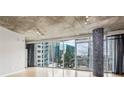 Bright living room features city views, sleek floors, accent tiling, and open layout at 950 W Peachtree Nw St # 812, Atlanta, GA 30309
