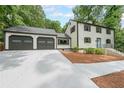 Traditional two-story home with a two-car garage and well-manicured lawn and shrubs at 9805 Buice Rd, Alpharetta, GA 30022