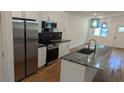 Modern kitchen featuring stainless steel appliances, a large island, and white cabinetry at 1092 Hillcrest Se Dr, Atlanta, GA 30316
