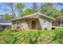Side view of home's exterior, showing siding, small windows, and tidy landscaping at 1422 Cassville Nw Rd, Cartersville, GA 30121
