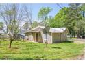 Home with tidy lawn plus metal roof and satellite dish at 1422 Cassville Nw Rd, Cartersville, GA 30121