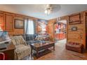 Comfortable living room with hardwood floors, wood paneling, and lots of windows for natural light at 1422 Cassville Nw Rd, Cartersville, GA 30121