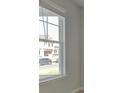 Bright room featuring a large window with white trim, offering a view of the neighborhood at 117 Compass Rd, Hampton, GA 30228