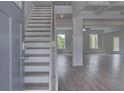 Bright entryway featuring a staircase, hardwood floors, and an open floor plan leading to the living areas at 145 Compass Rd, Hampton, GA 30228