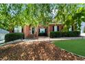 Beautiful brick home featuring manicured landscaping, a pathway to the front door, and lush green lawn at 3737 Falls Trl, Winston, GA 30187