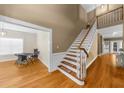 Open foyer with hardwood floors, staircase, and views into the dining and living areas at 3737 Falls Trl, Winston, GA 30187