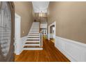 Welcoming foyer with hardwood floors, a grand staircase, and neutral wall colors at 3737 Falls Trl, Winston, GA 30187