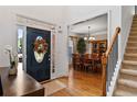 Foyer with hardwood flooring, dining room view and staircase at 7198 Golfside Se Dr, Covington, GA 30014
