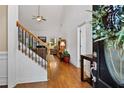 Inviting foyer featuring hardwood floors, staircase, and a view into the living room at 7198 Golfside Se Dr, Covington, GA 30014