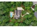 Breathtaking aerial perspective of estate home with a private pool, long driveway, and beautiful landscaping at 140 Silvermere, Fayetteville, GA 30215