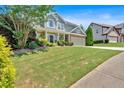 Beautiful two-story home showcasing a lush green lawn and a welcoming covered front porch at 204 Sawtooth Ct, Canton, GA 30114