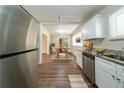 A bright kitchen boasts stainless steel appliances, granite countertops, and modern white cabinetry at 3904 W Hilda Cir, Decatur, GA 30035