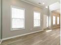 Living room featuring light wood floors, with large windows, lots of light and neutral paint at 1029 Chaterly Ct, Riverdale, GA 30296