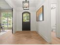 Entry foyer showcasing hardwood flooring, stylish light fixture, and an arched front door at 2461 Fernleaf Nw Ct, Atlanta, GA 30318