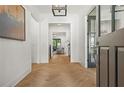 Inviting foyer with light herringbone wood floors and views into living areas at 2461 Fernleaf Nw Ct, Atlanta, GA 30318